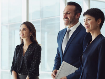 What a successful meeting! Cropped shot of a diverse group of businesspeople standing together and smiling after a successful meeting in the office